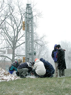 An FHWA team begins installing the new weather station. Once the station is up and running, it will gather data to support FHWA research on road weather management.