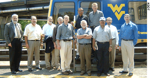 A Kansas delegation visited West Virginia University to study the automated transit system that links the school's campuses. The delegation is shown here standing outside one of the automated transit vehicles.