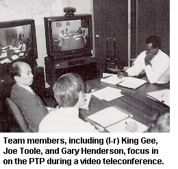 Team members, including (l-r) King Gee, Joe Toole, and Gary Henderson, focus in on the PTP during a video teleconference.