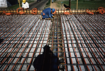 Workers install hydronic hoses in the North 15th Avenue Bridge.