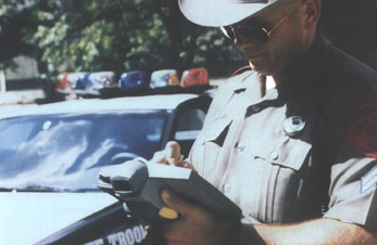 Officer uses a hand-held computer to complete an accident report