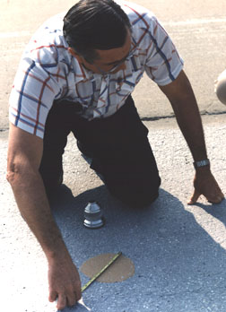 A manually performed sand patch test for measuring the macrotexture depth of pavement surfaces.