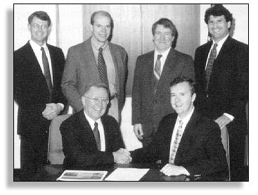 At the CRADA signing are (seated) R&D Associate Administrator Bob Betsold, SES President Scott Clements, (standing) FHWA's Dennis Sixbey, Roy Trent, SES's James Mekemson, and Nicholas Gagarin.