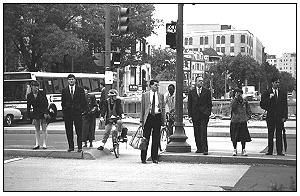 Photo of pedestrian crossing city street with an island.