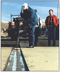 Photo of a worker installing a fiberglas composite bridge 