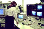 woman monitors closed-circuit television cameras