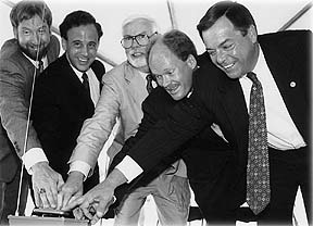 5 Men touching a briefcase