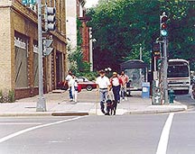 blind pedestrian walking in street with guide dog