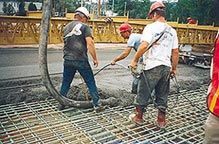 Hot Mix Asphalt being applied by workers