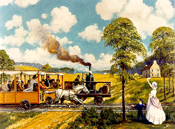 Image:  A woman and small boy wave to two racing railroad vehicles.