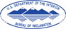 BOR Logo featuring several mountain peaks. The suggestion of a lake is made by showing the mountian peaks reflected below them. The logo says "US Department of the Interior Bureau of Reclamation" at the edges. It is oblong in shape.