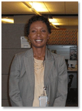Photo of FHWA's Associate Administrator for Planning, Environment and Realty-Gloria Sheperd. She is standing in the hallway of her office.