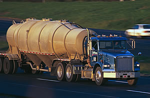 Photo showing a truck transporting hazardous materials down a highway.