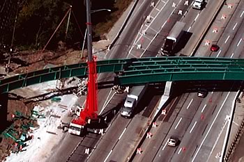 Photo showing a new bridge being built over a highway.