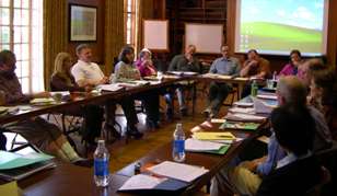 Photo of the Midwest MSAT Peer Exchange Participants sitting in a conference room at tables, engaging in discussions.