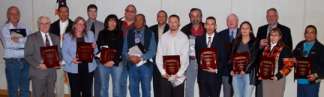 Caption: Group photo of North Dakota Tribal Consultation PA Plaque Honorees. Back row: Byron Olson, Archaeologist Standing Rock THPO; Conrad Fisher, THPO Northern Cheyenne;  Mark Schrader,     FHWA ; Curley Youpee, Director Cultural Resources Department Fort Peck Assiniboine and Sioux Tribes; Franky Jackson, Consultant to Lower Sioux Indian Community; Calvin Grinnell, Cultural Resource Specialist, Mandan Hidatsa & Arikara Nation;  Allen Radliff, FHWA ; Kent Good, Consultant to NDDOT; Elgin CrowsBreast, THPO Mandan Hidatsa Arikara Nation; Front Row: Francis Ziegler, NDDOT Director; Jeani Borchert, NDDOT Tribal Consultation Specialist; Pam Halverson, THPO Lower Sioux Indian Community; Ambrose Littleghost, Cultural Advisor, Spirit Lake Dakotah Nation; Richard Bird, Jr., Chairman Economic Committee and Councilman at Standing Rock Sioux Tribe; Scott German, Vice-Chairman, Sisseton Wahpeton Oyate; Shannon Blue, President Lower Sioux Indian Community; Dianne Desrosiers, THPO Sisseton Wahpeton Oyate.