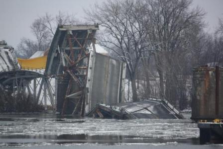 December 2009, showing the Crown Point Bridge being removed from Lake Champlain by means of blasting, in anticipation of the construction of a replacement structure. 