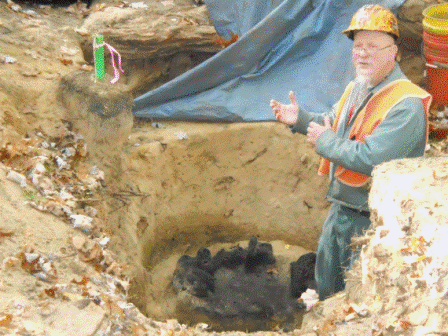 Photo of Michael J. Hambacher, PhD, Field Director with charcoal in feature. 