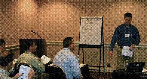 Caption: David Grachen stands at front of classroom during NEPA training. Photo by Dave Gamble. 