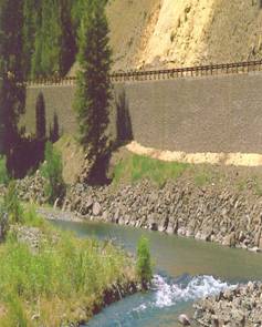 Photo of a raised road and support wall next to a stream. Courtesy of Wyoming DOT.