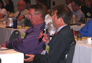 Caption: Photo of Fred Skaer commenting during the opening remarks of the National Environmental Conference. Don Cote, Team Manager for the Environment Technical Service Team sits to his right (left in photo ). (Photo by Stephanie Stoermer.)