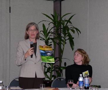 Caption: Photo of Kimberly Majerus introducing the multi-agency Eco-Logical publication as Bethaney Bacher-Gresock looks on. (Photo by Stephanie Stoermer.) 