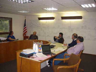 photo of five people seated at a U shaped table