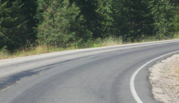 photo of a curve in a two lane road