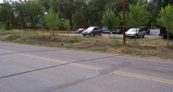 photo of a two lane road by a parking lot