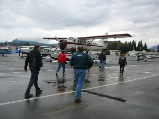 photo of people on a runway near an airplane