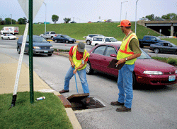 MACTEC SUE Specialists open and inspect a storm sewer inlet located on highway on-ramp as part of MACTEC's Interstate 64 SUE Services contract with the Missouri DOT.