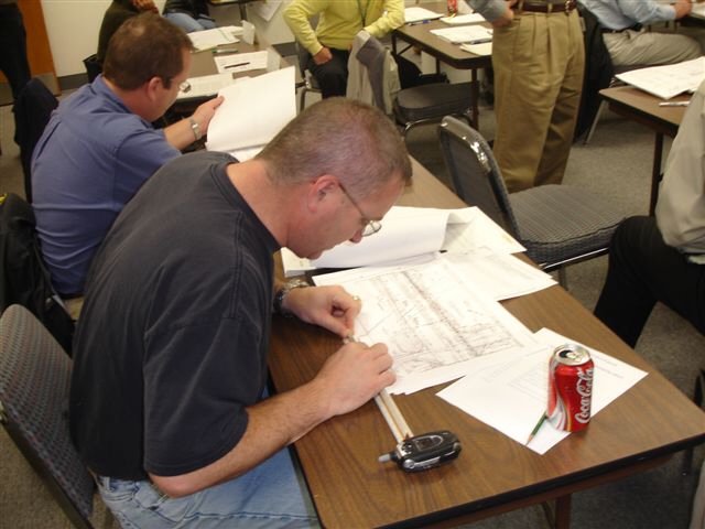 Attendees identifying utility conflicts in the plans, preparing a utility conflict matrix, and identifying the locations that need SUE services