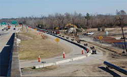 Road construction site with the conduit laid out in preparation for installation.