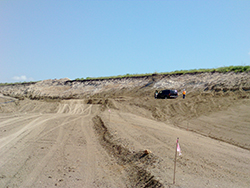 Photo showing location where the highway is in a 25-foot cut section, requiring adjustment of a utility pipeline.