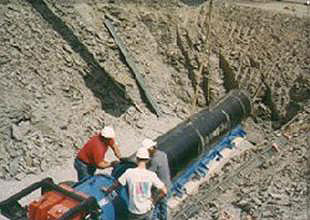 Figure 7 on this page is a picture of a track-type auger boring operation.